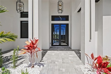 View of exterior entry featuring french doors and