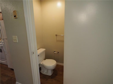 Bathroom featuring wood finished floors, toilet, 