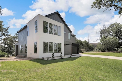 View of side of property with concrete driveway, 