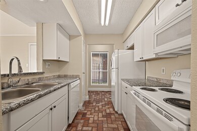 Galley style kitchen with washer and dryer connections