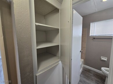 Bathroom with wood finished floors, baseboards, to