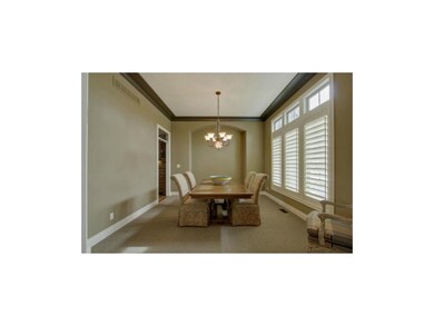 Formal dining room.  Home has plantation shutters 
