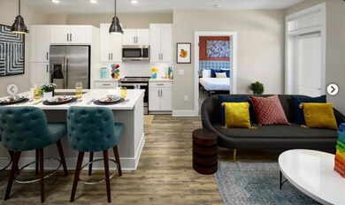 Kitchen featuring white cabinetry, stainless steel