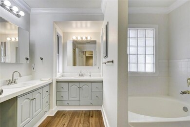 Full bathroom featuring crown molding, wood finis