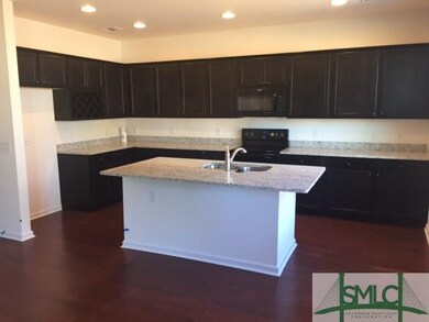 upgraded kitchen with granite and wood floors