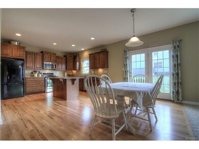 Spacious eat-in area with doors leading to back ya