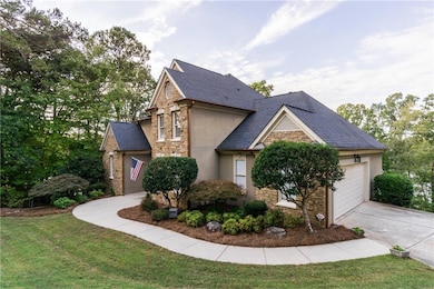 View of front of home with a front lawn and a gara