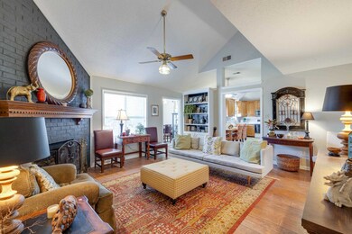 Living area with visible vents, a brick fireplace,
