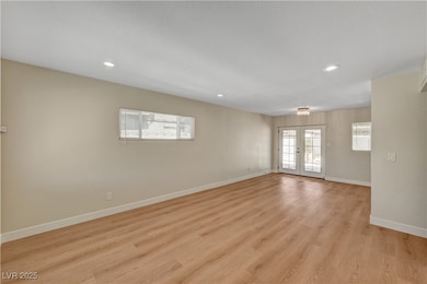 Empty room featuring baseboards, light wood-style