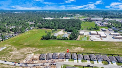 An aerial view of a spacious subdivision lot, high