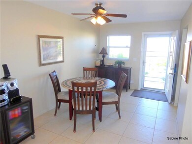 Dinning area with fan leading to kitchen and view