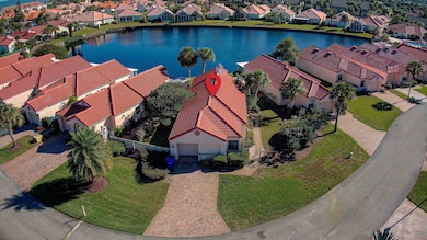 Aerial view of residential area featuring a nearby body of water