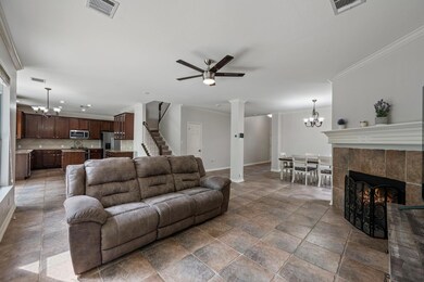 Living area with a chandelier, a ceiling fan, bas
