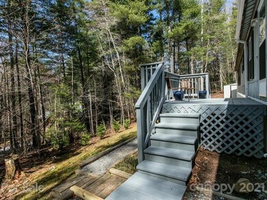 Front porch and wooded lot. Room for a flower or v