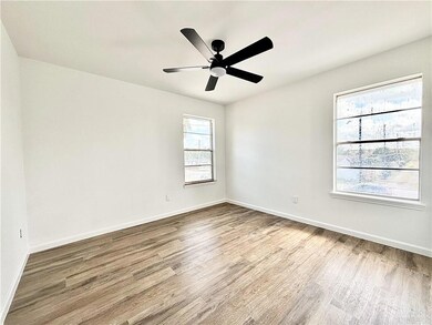 Empty room with wood-type flooring and ceiling fan