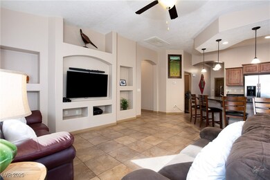 Living room featuring arched walkways, ceiling fan
