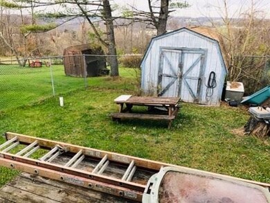 Partially fenced back yard, shed included!