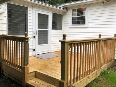 Newer front deck leading into the covered front po