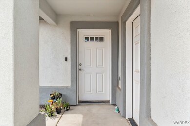 View of exterior entry featuring stucco siding