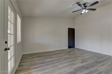 Unfurnished room featuring baseboards, a ceiling f