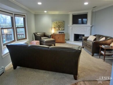 Family room with bay windows, wood burning  firepl