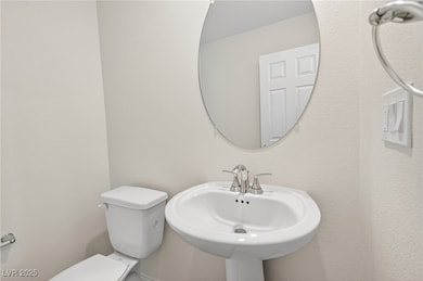 Half bathroom featuring toilet and a sink