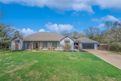 Single story home featuring concrete driveway, an