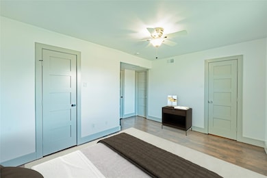 Unfurnished bedroom featuring ceiling fan and dark