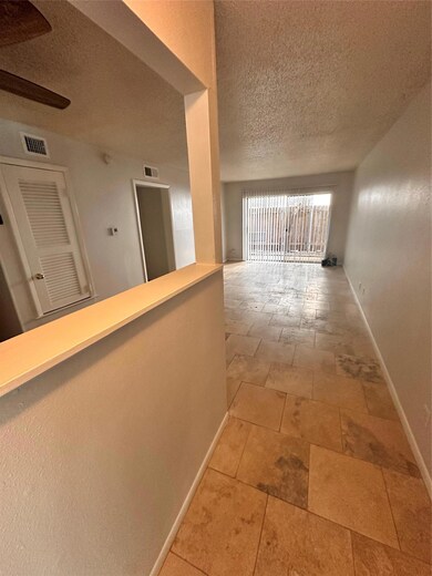 Hall featuring a textured ceiling