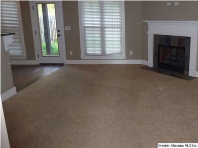 Den that is open to Kitchen & has a beautiful fire