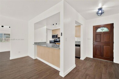 Tiled wood-like flooring throughout