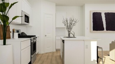 Kitchen featuring white cabinetry, sink, a kitchen