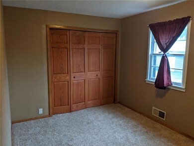 Bedroom with large closet and organized sections.