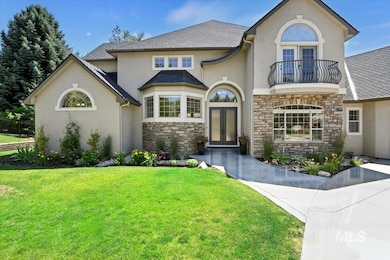 French provincial home with french doors, a balcony, stone siding, and stucco siding