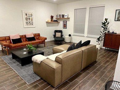 Living area with wood tiled floors and baseboards