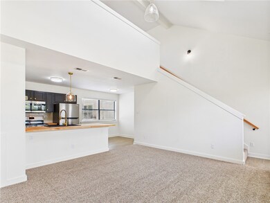 Unfurnished living room featuring light carpet, be