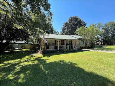 View of front of home featuring a metal roof and covered porch