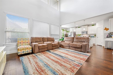 Living area featuring dark wood-style flooring, r