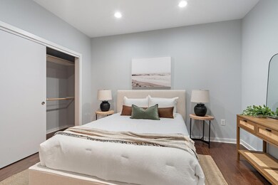 Bedroom with dark wood-type flooring, recessed lig