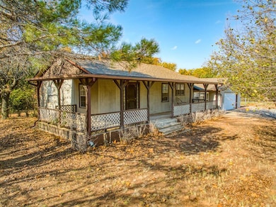 View of front of house featuring a porch, an attac