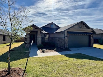 View of front of home featuring brick siding, driveway, and an attached garage