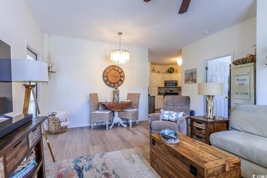 Living room featuring ceiling fan with notable cha