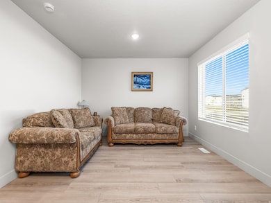 Living room with baseboards and light wood-style flooring