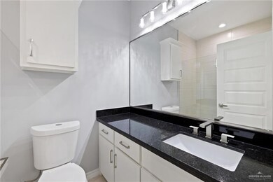 Bathroom featuring vanity, recessed lighting, and a tile shower