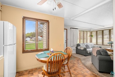 Dining room with a ceiling fan and baseboards