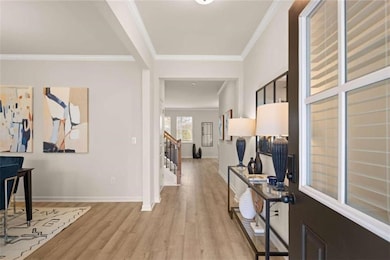Foyer featuring light wood finished floors, basebo