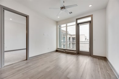 Empty room featuring a ceiling fan, light wood-type flooring, and recessed lighting