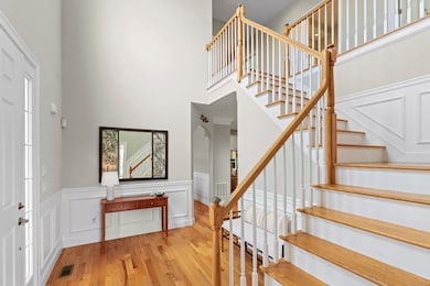 Enter a lofted foyer. Turned staircase and custom millwork throughout.