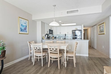 Dining room featuring a textured ceiling and light wood-style floors