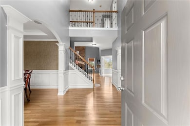 Foyer entrance with light wood-style flooring, a w